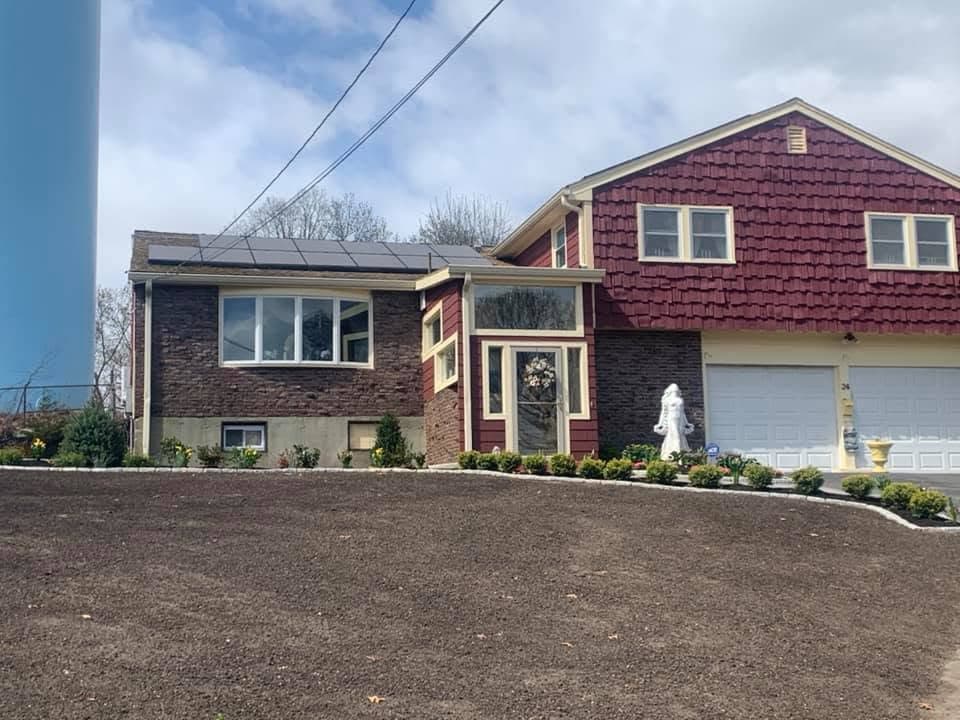Front yard graded and loamed with new foundation shrubs planted.